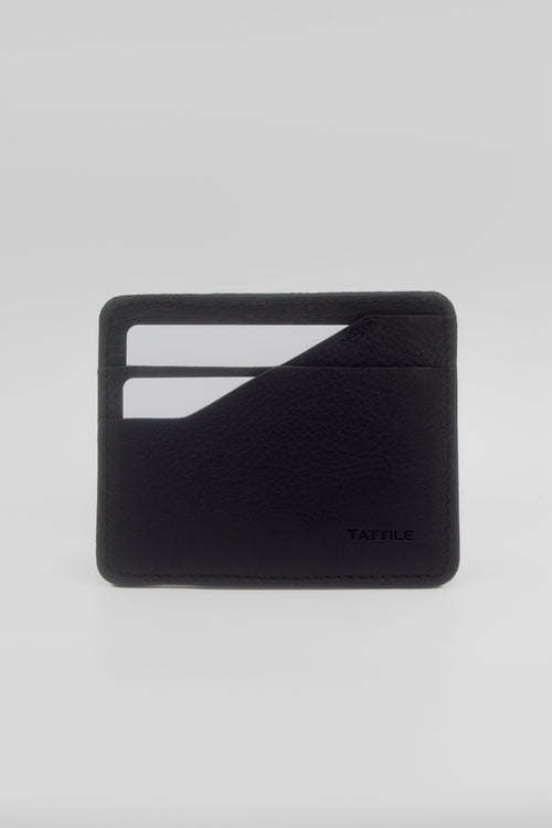 A minimalist black leather card holder wallet with a textured pebbled finish, featuring two card slots on the front and the debossed brand name 'TATILE' in the bottom right corner, set against a light gray background.